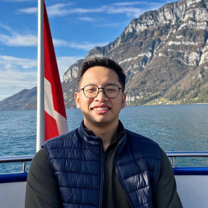 Faiz Krisnadi beside a lake in Switzerland